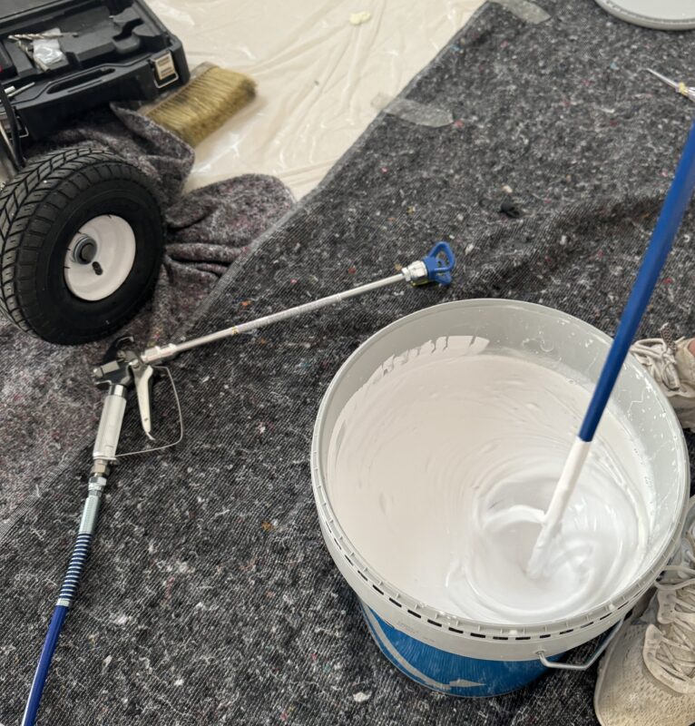 Professional airless painting setup with interior wall paint